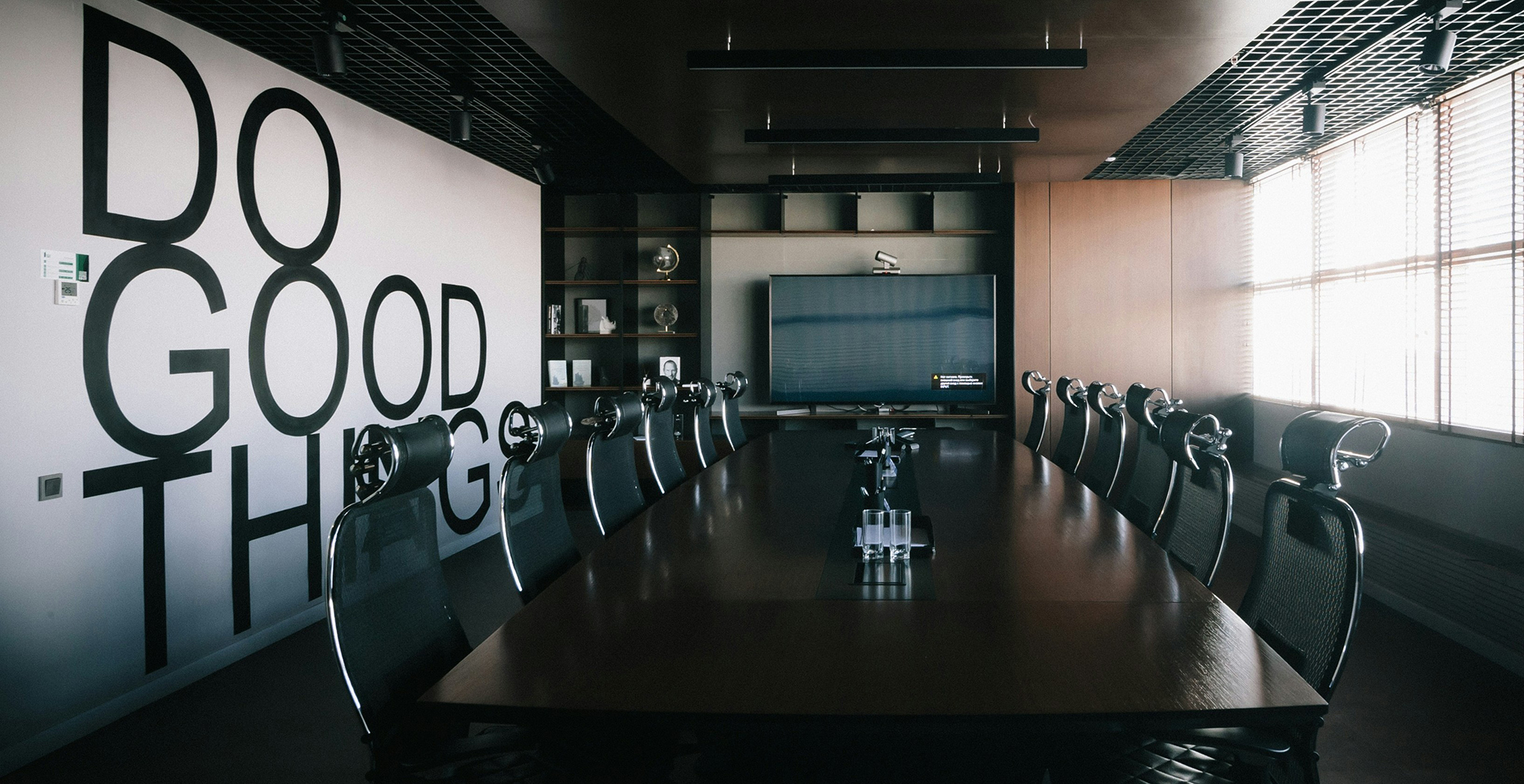 conference table with do good things mural painted on wall